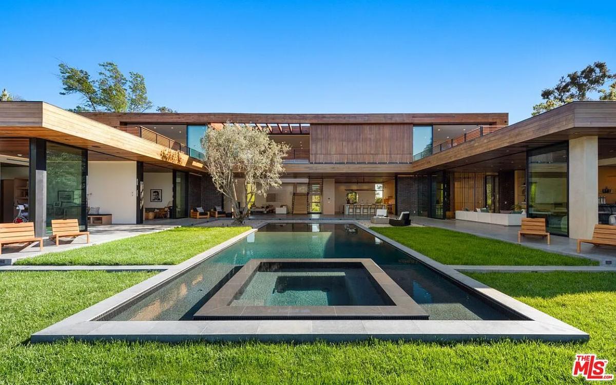 Rear view of the mansion with a pool.