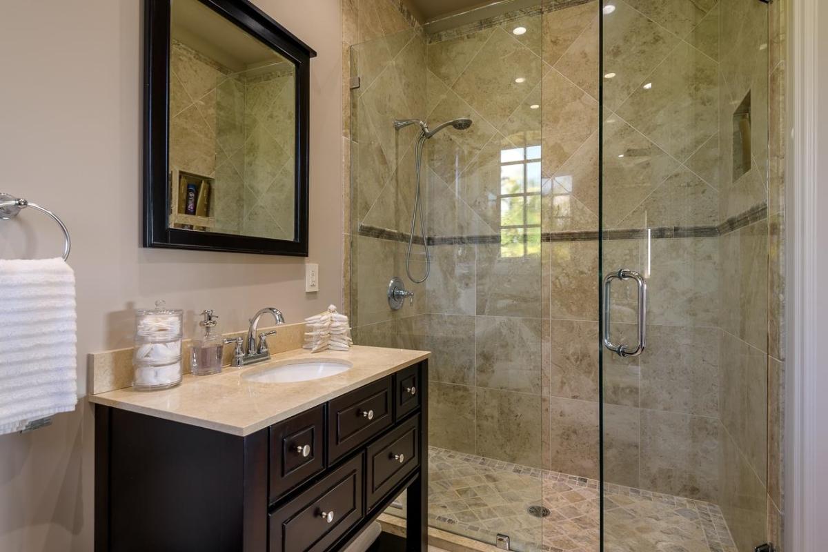 Bathroom with a custom-made vanity and a walk-in shower.