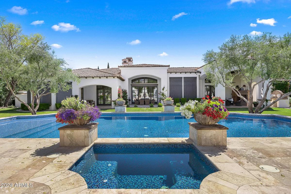 Rear view of the mansion with a pool.