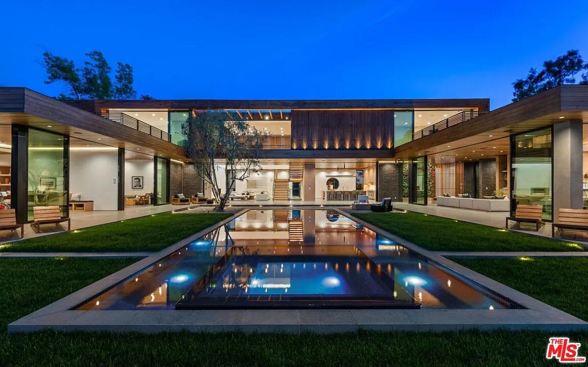 Rear view of the mansion with a pool.