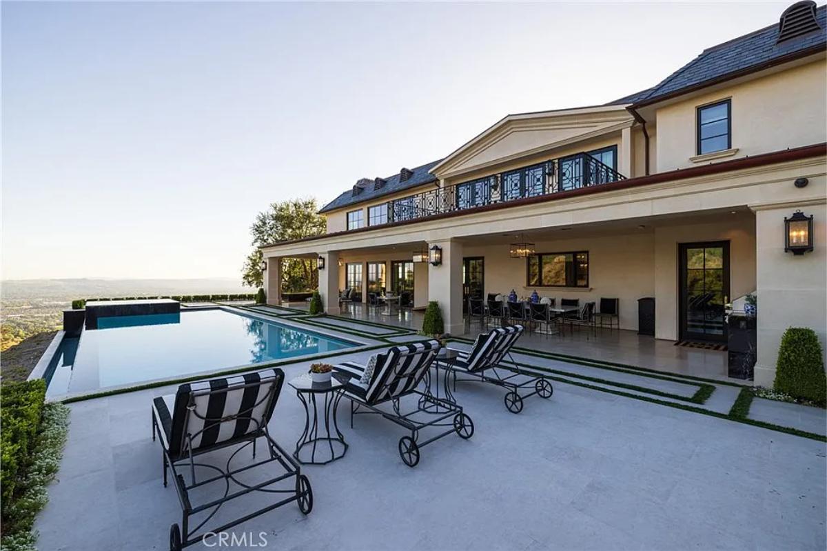 Pool with a jacuzzi and lounge chairs.