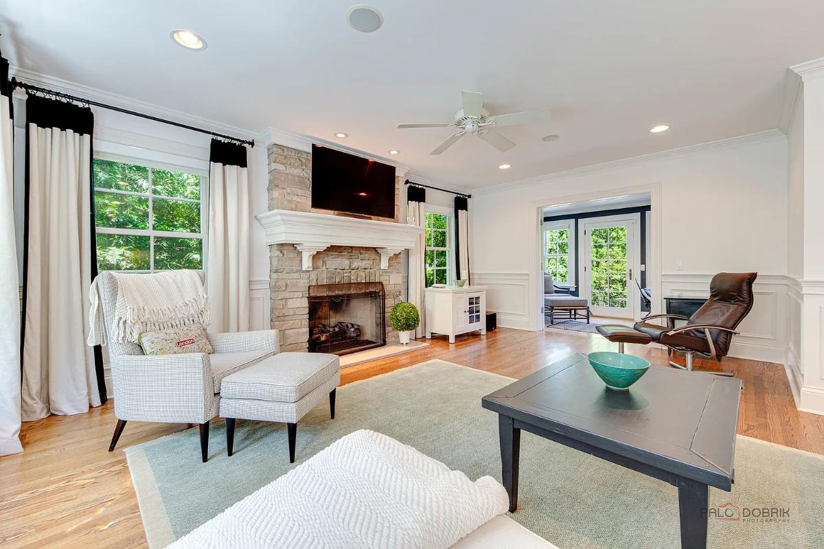 Living room with hardwood floors and a fireplace.