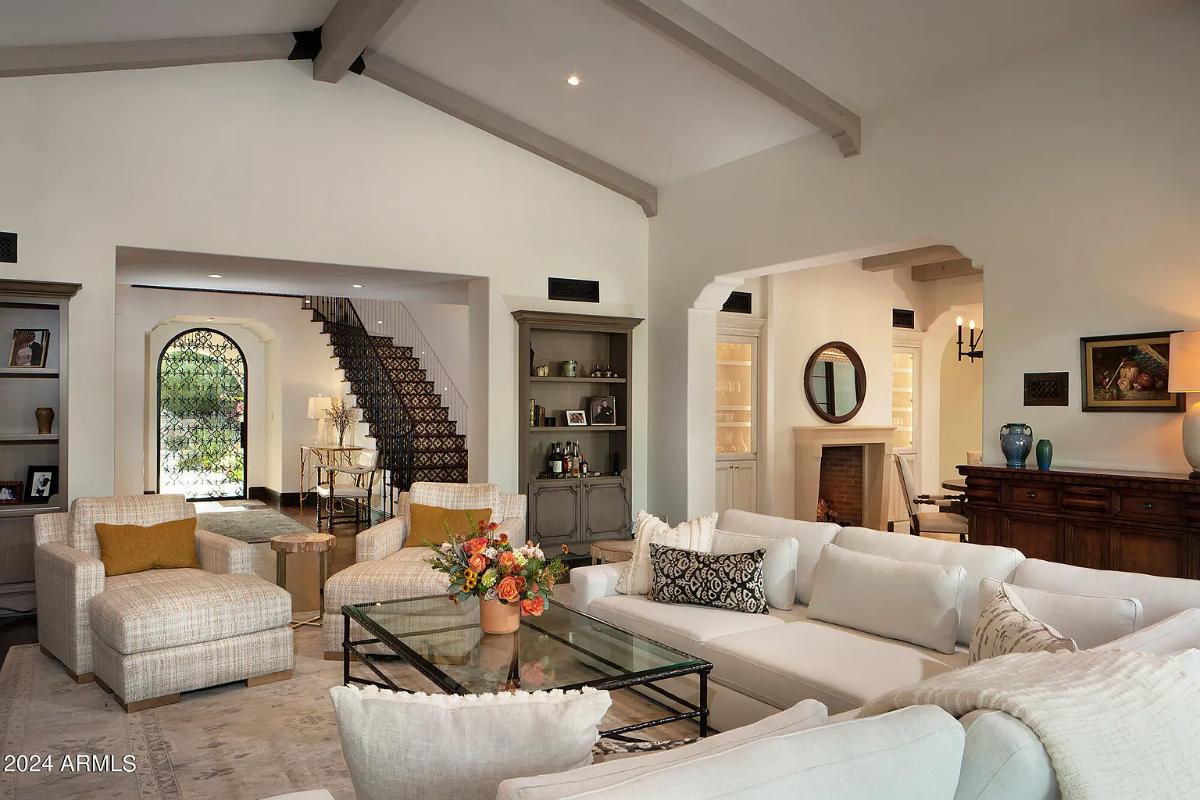 Living room with couches and a glass center table.