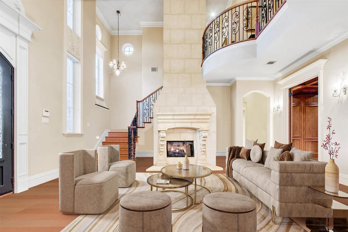 Living room with high ceilings and a fireplace.