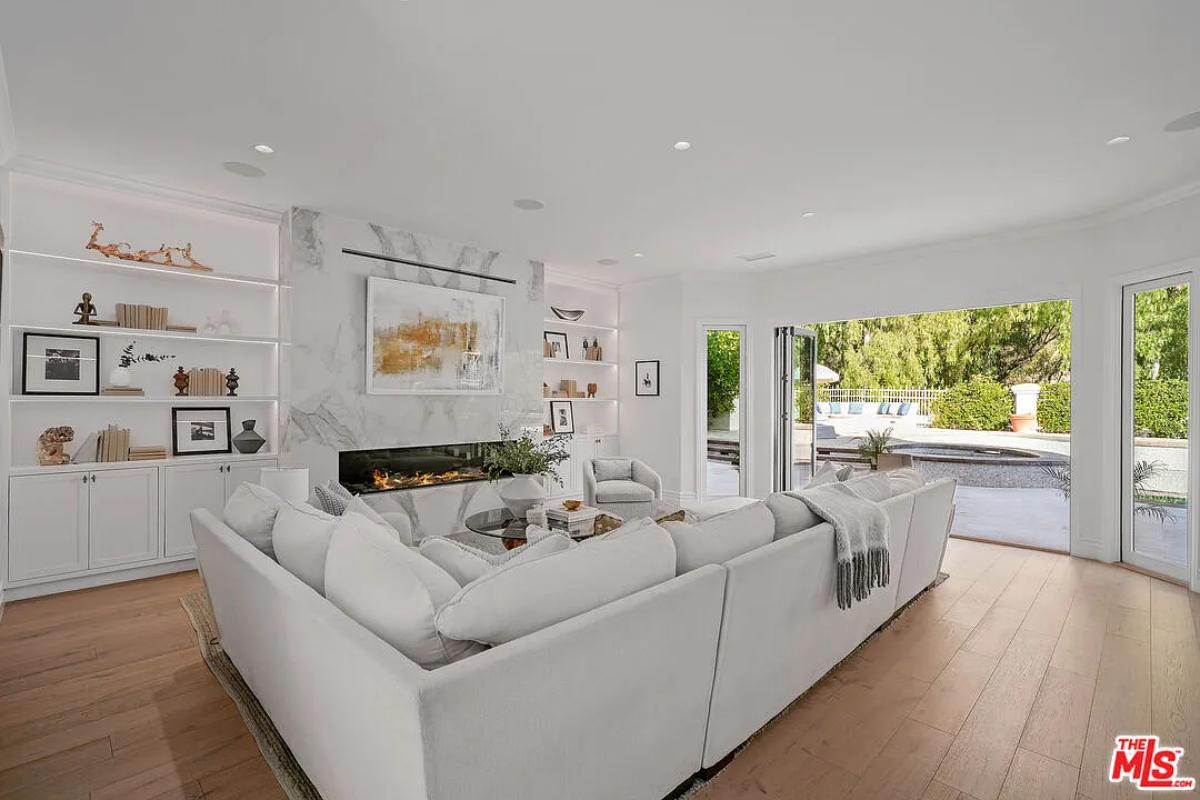 Living room with couches and a fireplace.