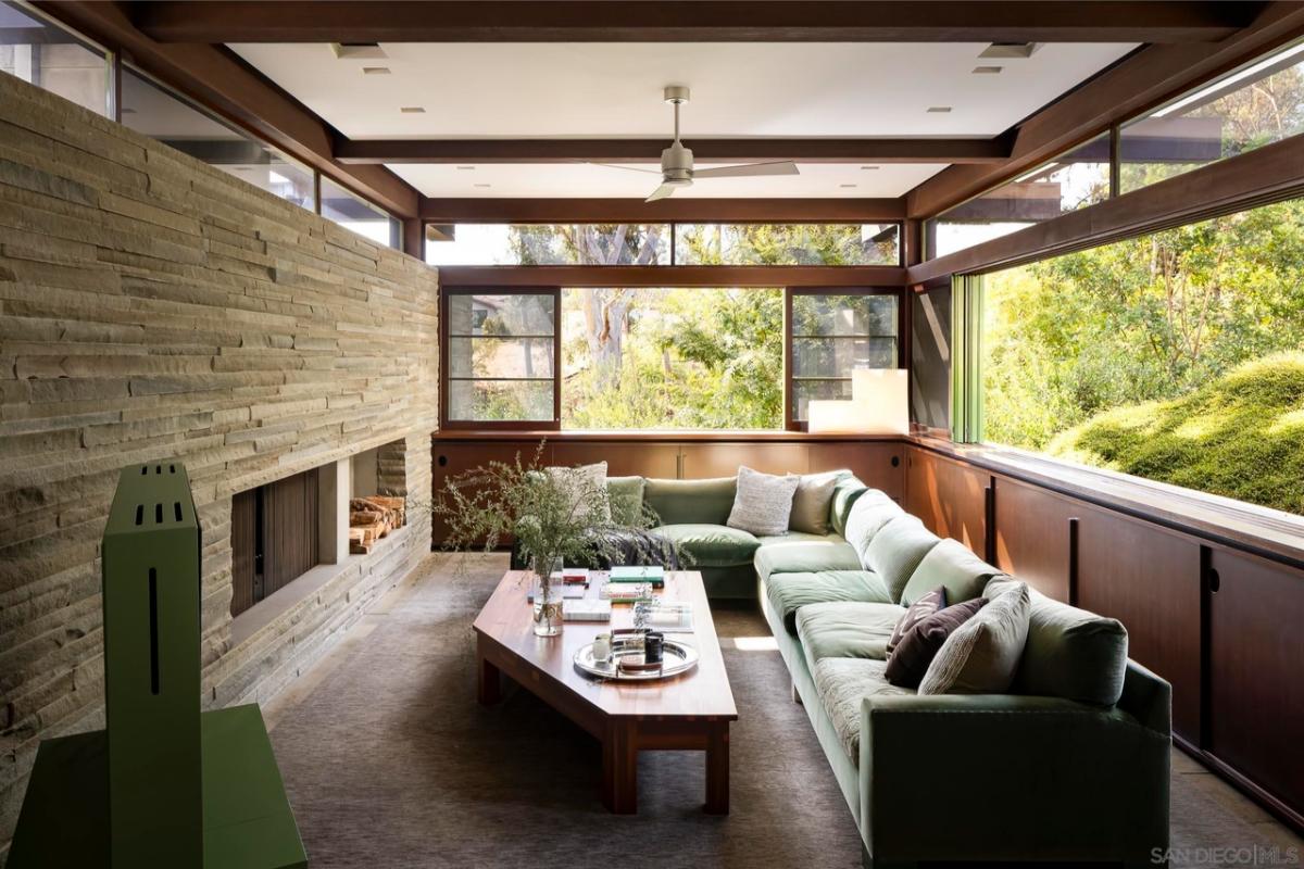Living room with couches and a fireplace.