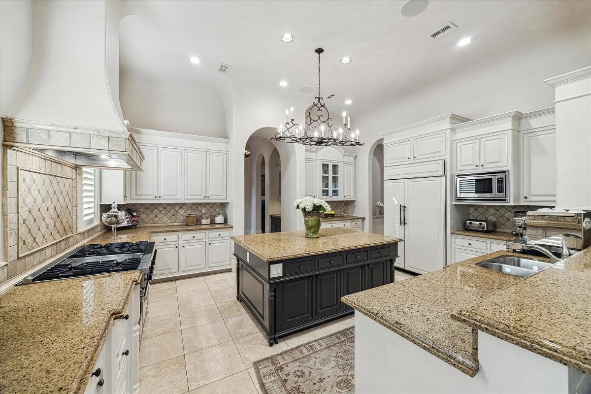 Kitchen with custom cabinetry and a center island prep area.