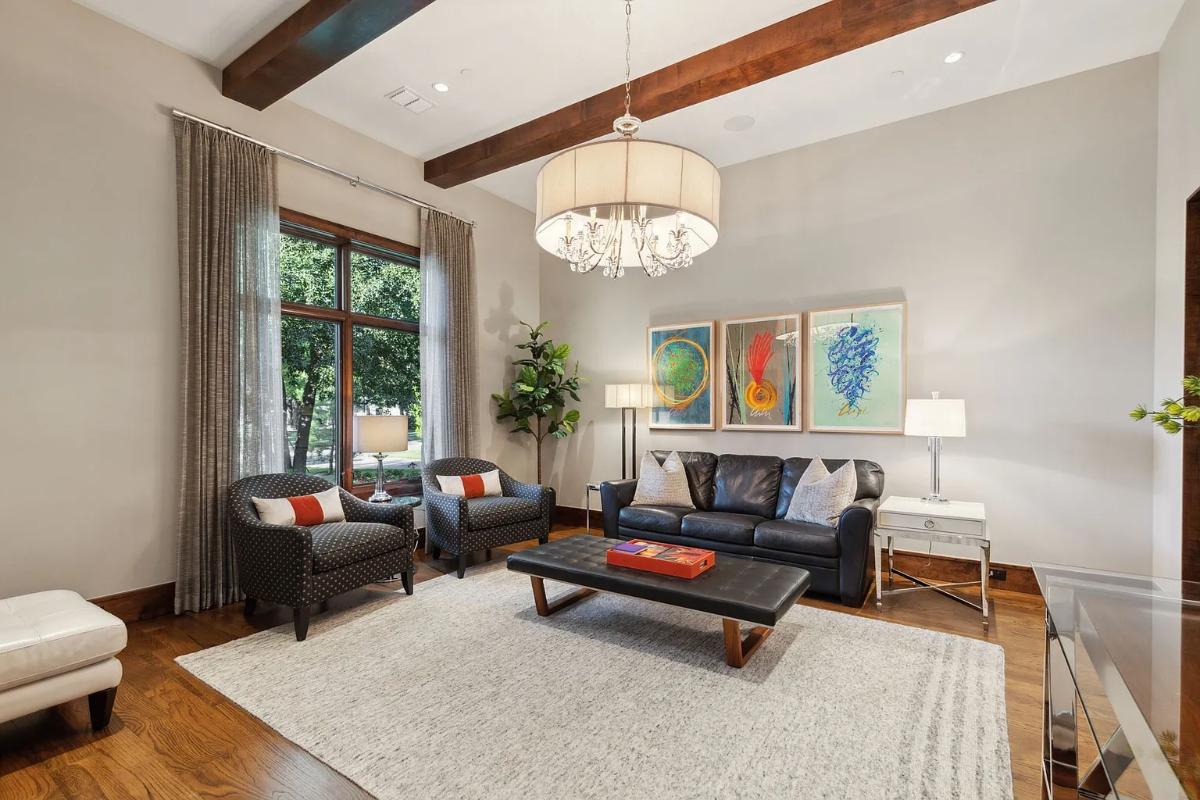 Living room with couches and a chandelier.