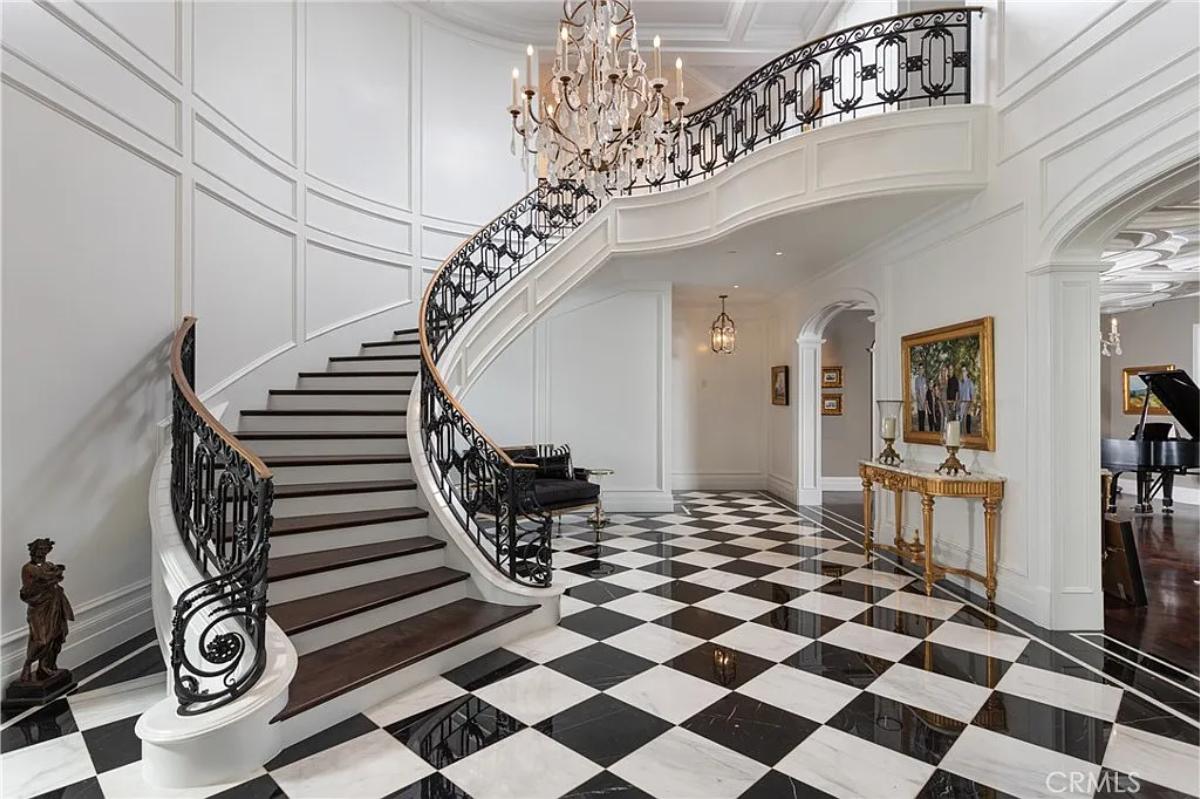 Foyer with a chandelier and stairs.