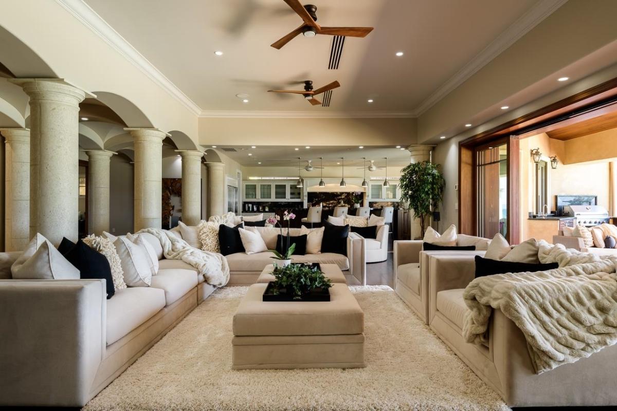 Living room with couches and custom lights.