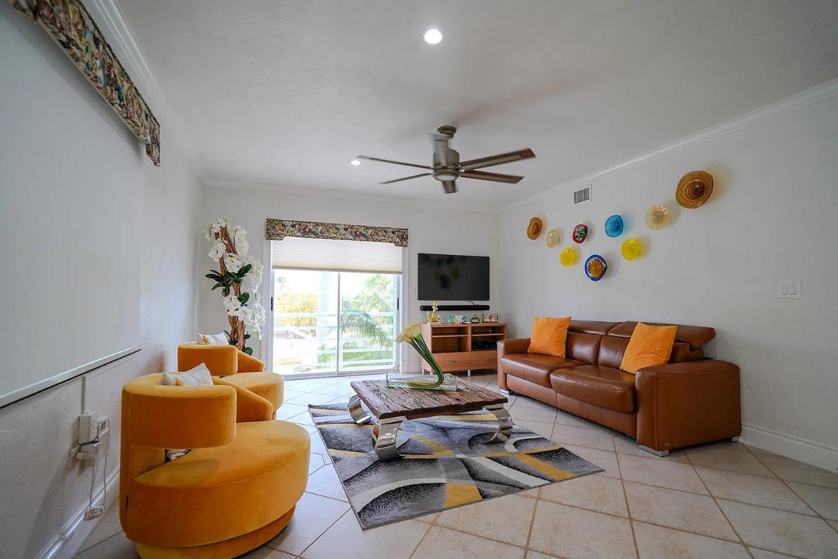 Living room with couches and glass doors.