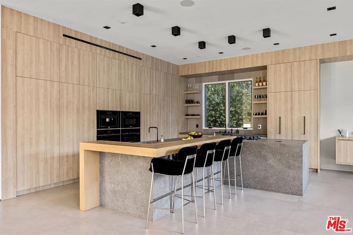 Kitchen with custom cabinetry and a counter breakfast bar.