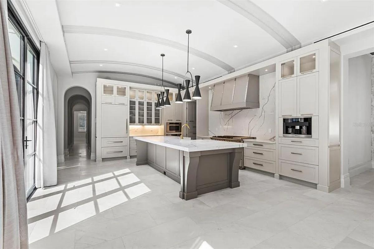 Kitchen with custom cabinetry and a center island prep area.