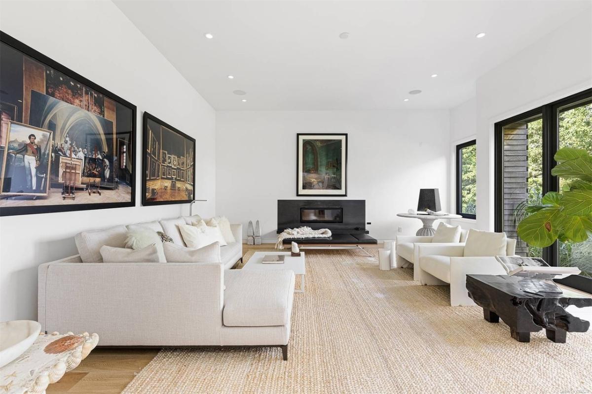 Living room with couches and a fireplace.