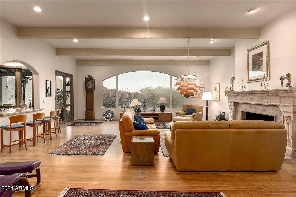 Living room with couches and a fireplace.