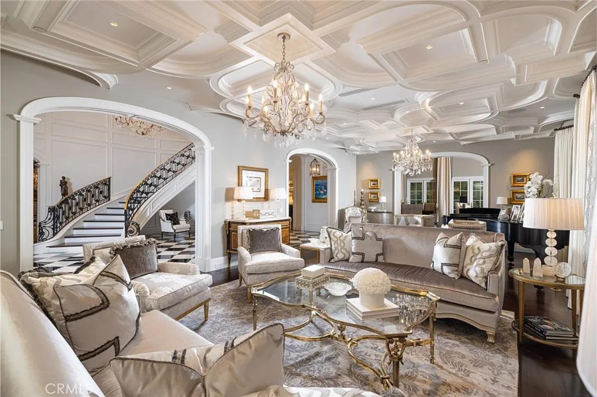 Living room with couches and chandeliers.