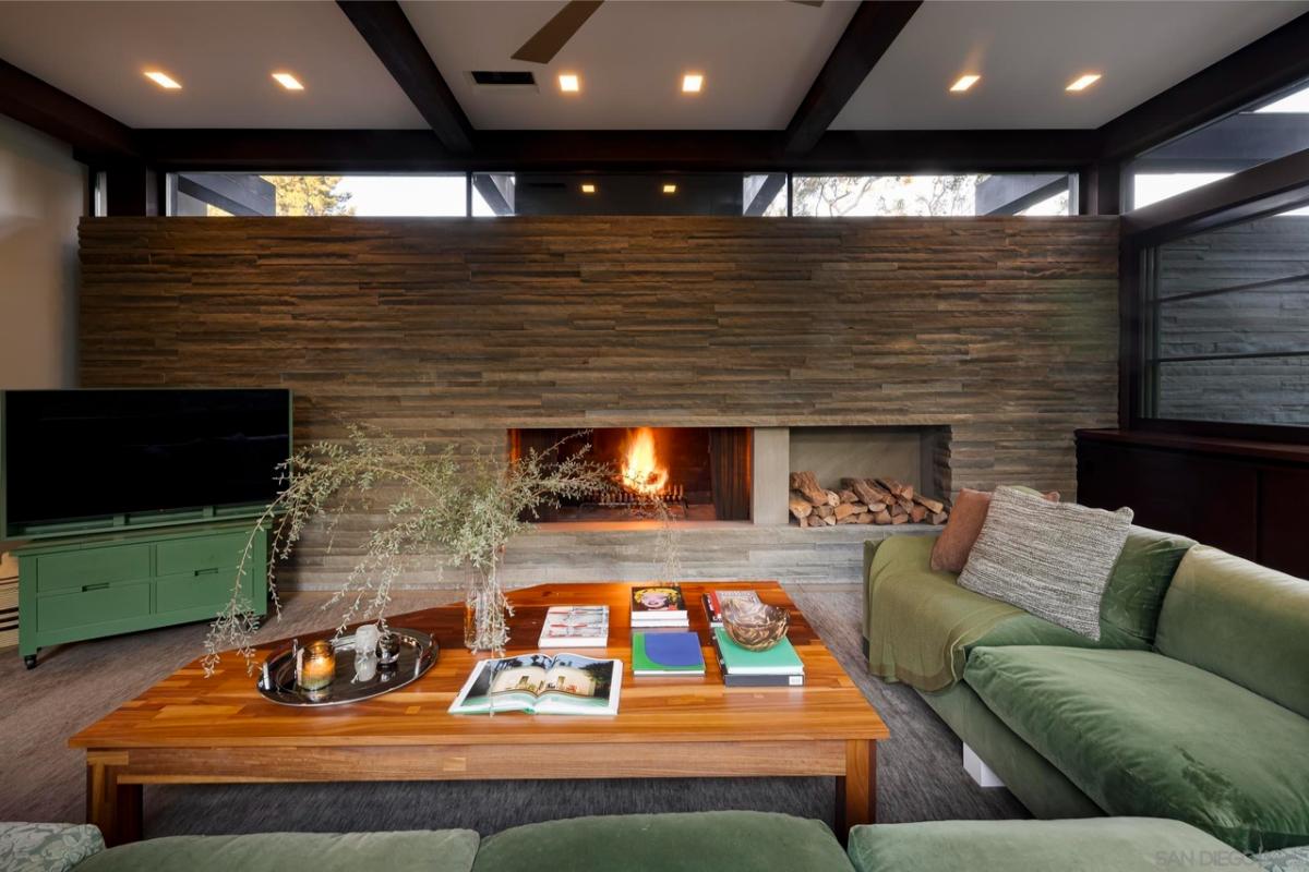 Living room with couches and a fireplace.