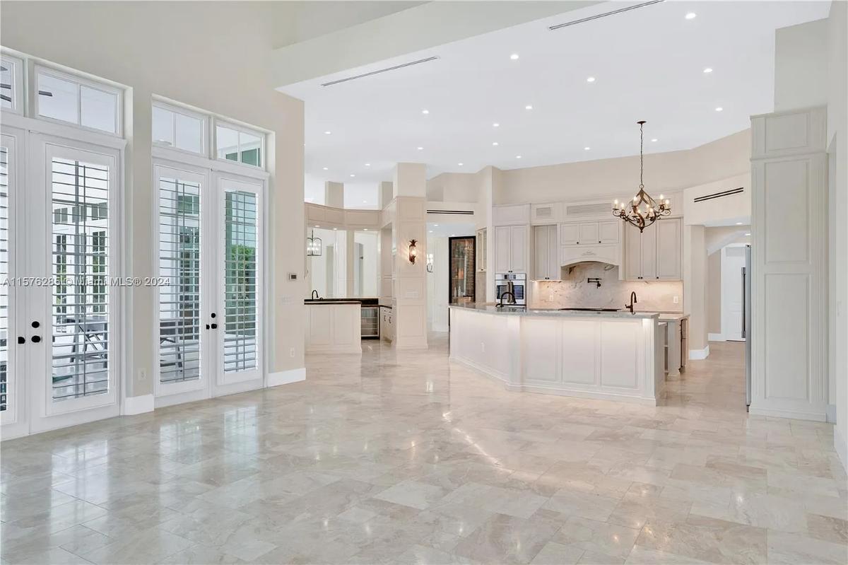 Kitchen with a chandelier and custom cabinetry.