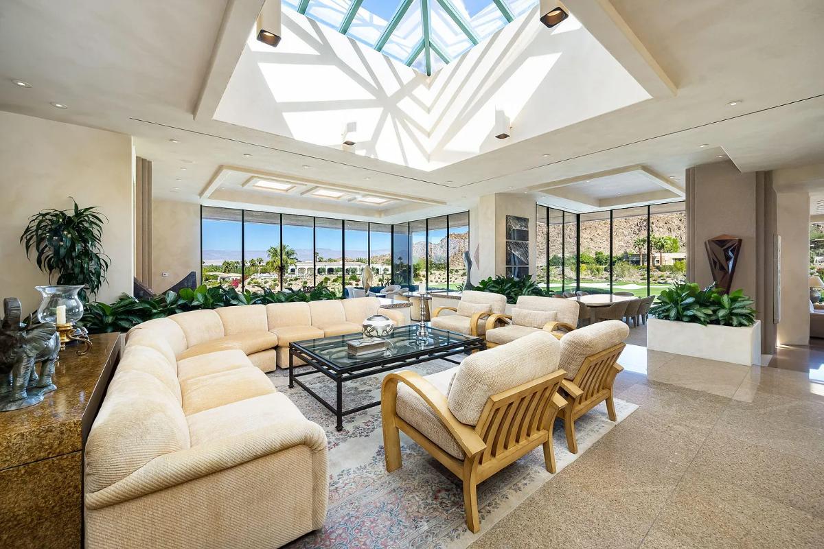 Living room with couches and skylight.