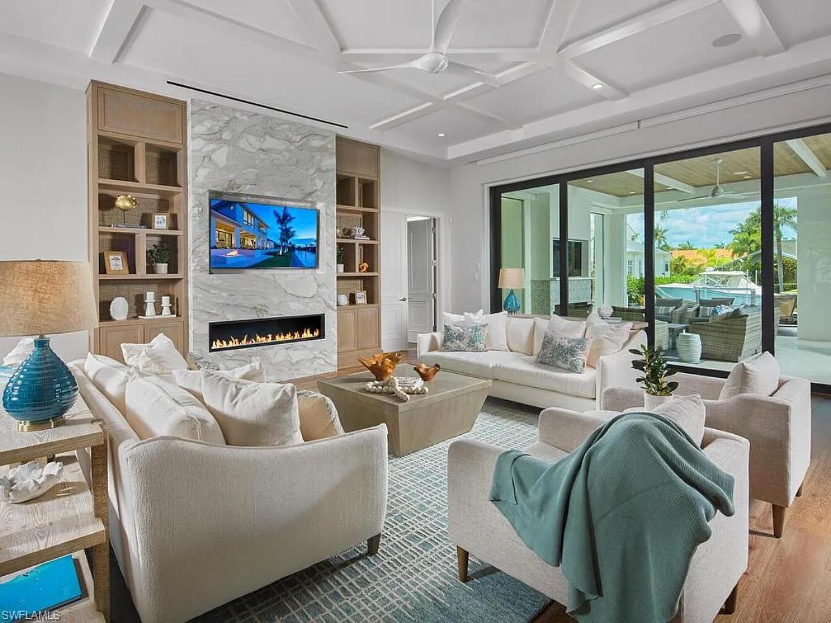 Living room with couches and a fireplace.