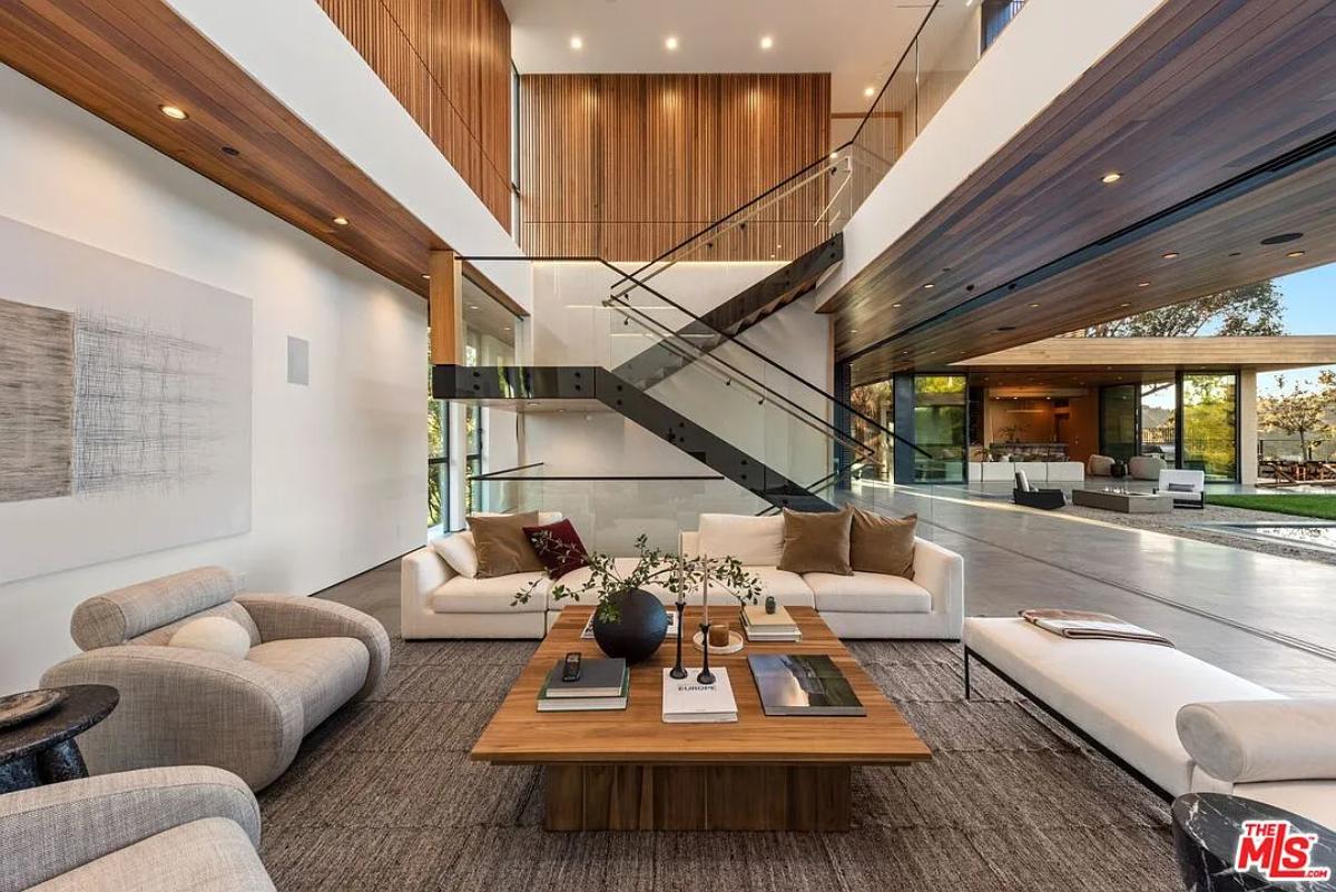 Living room with couches and high ceilings.