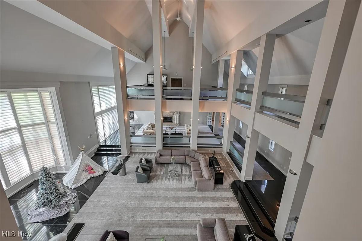 Living room with couches and high ceilings.
