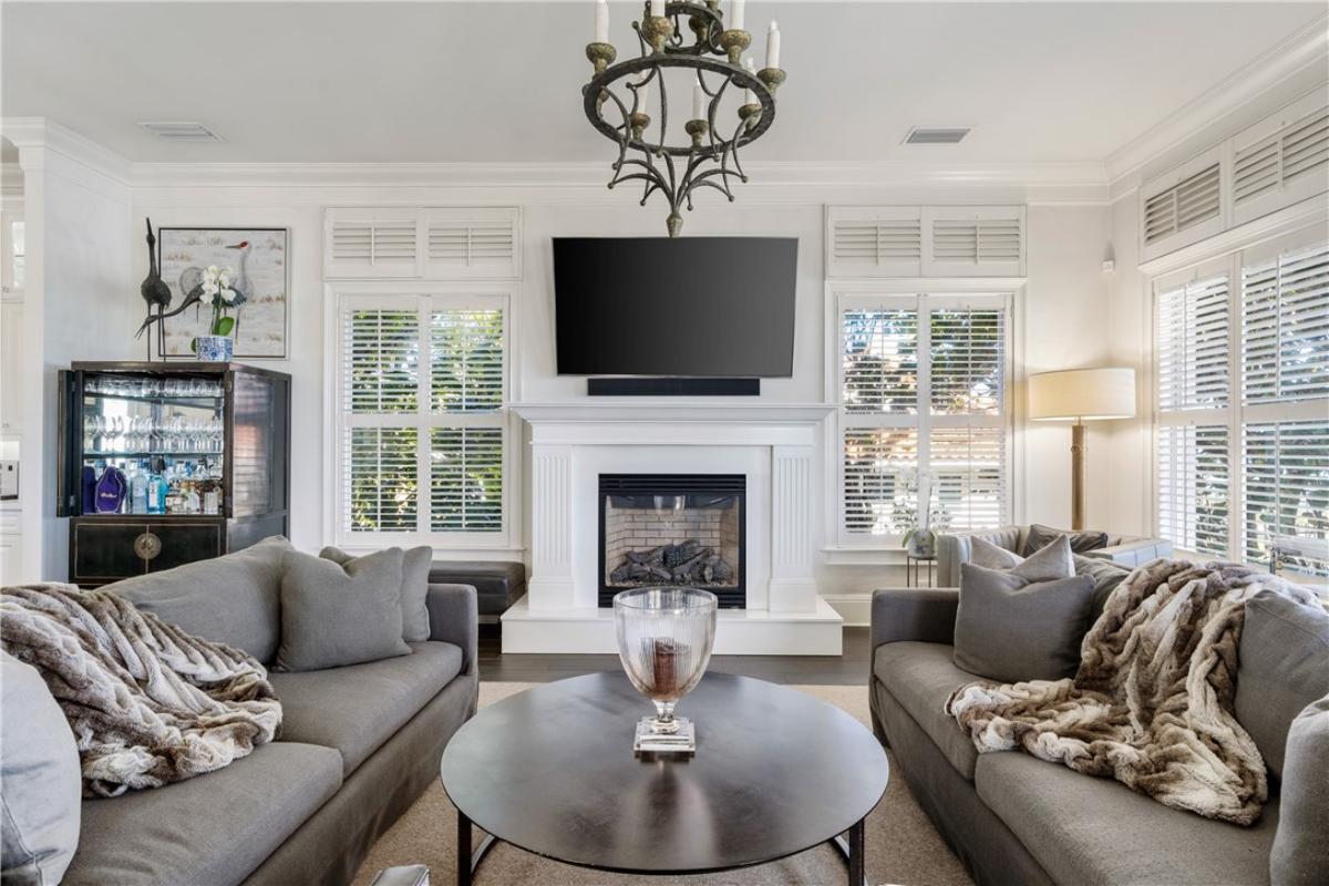 Living room with couches and a fireplace.