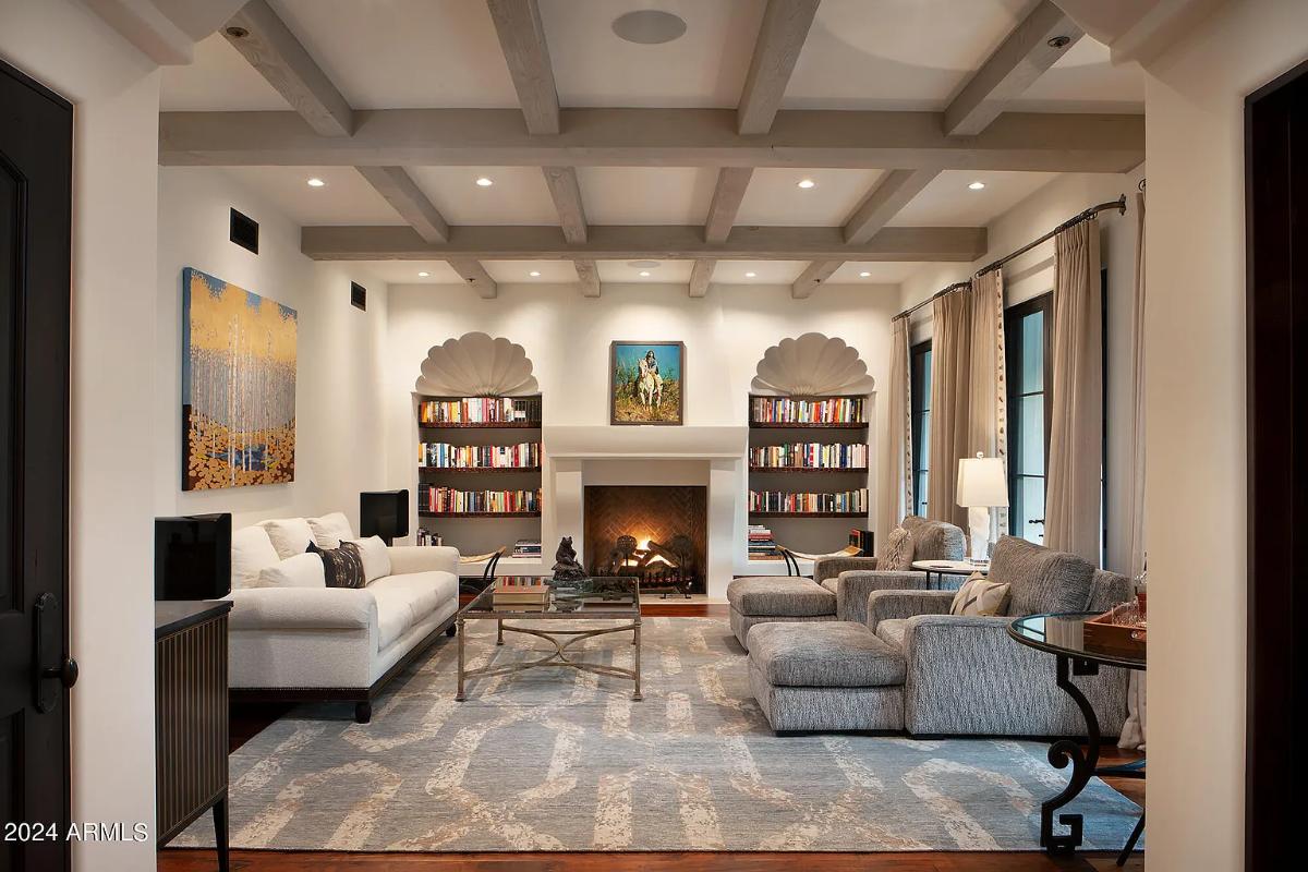 Living room with couches and a fireplace.