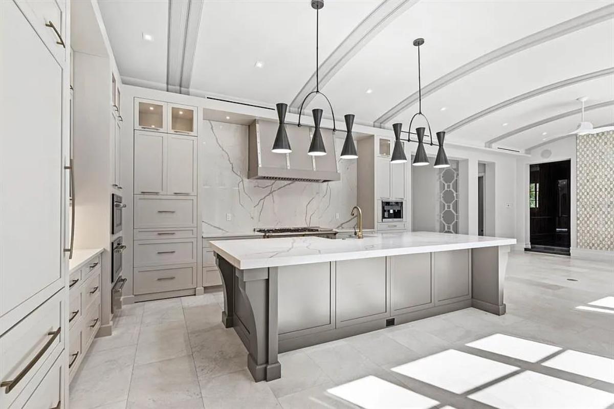 Kitchen with custom cabinetry and a center island prep area.