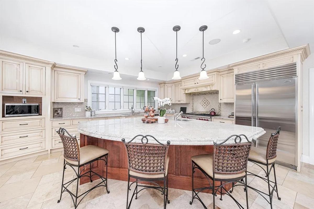 Kitchen with custom cabinetry and a counter breakfast bar.