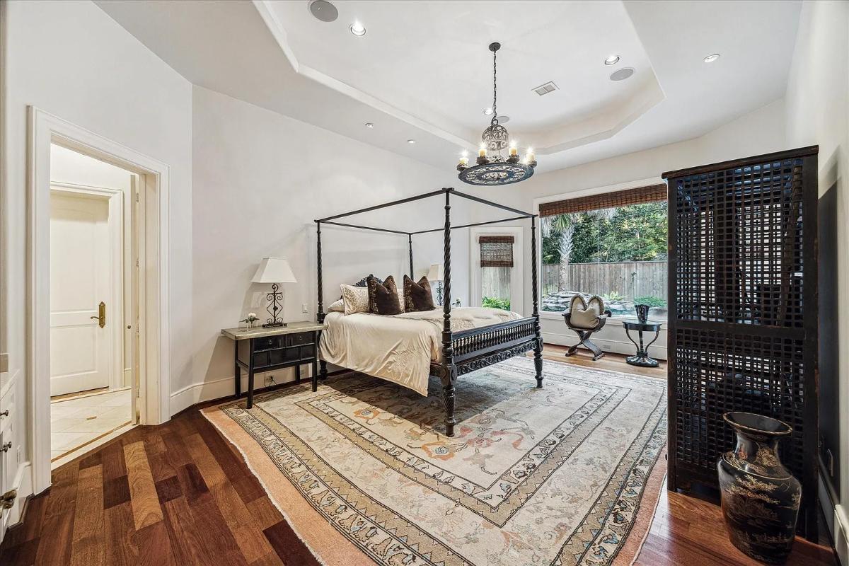 Bedroom with a large bed and hardwood floors.