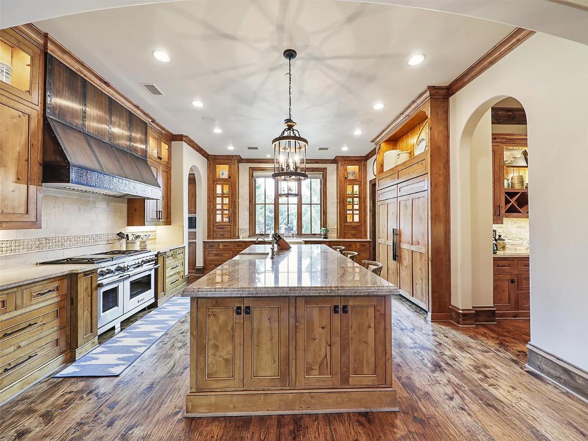 Kitchen with custom cabinetry and a center island prep area.