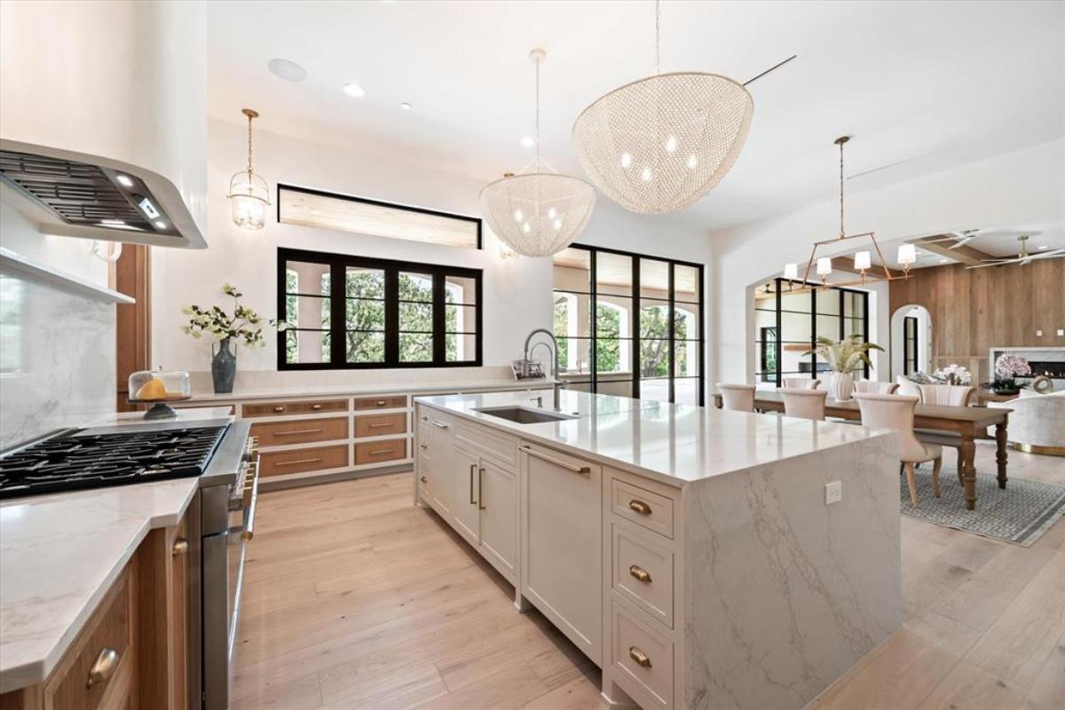 Kitchen with custom cabinetry and an island prep area.