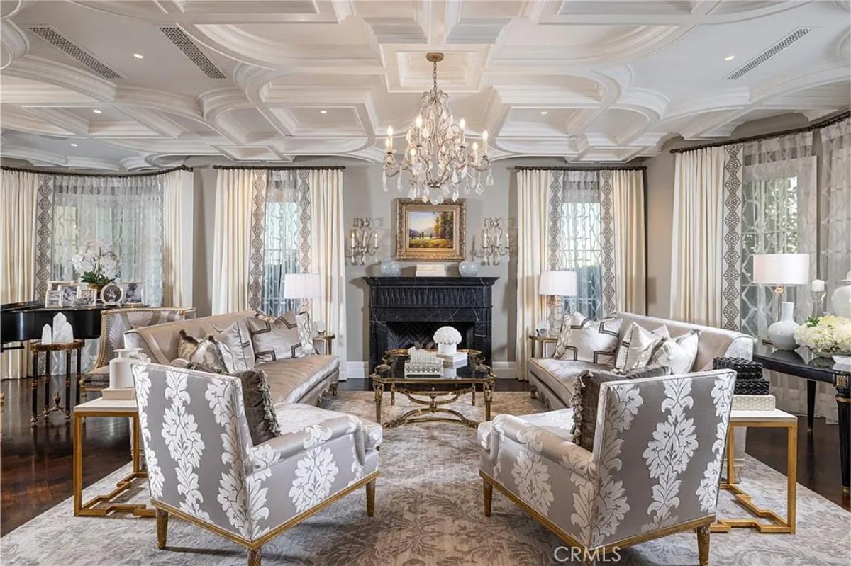 Living room with couches, a chandelier and a fireplace.