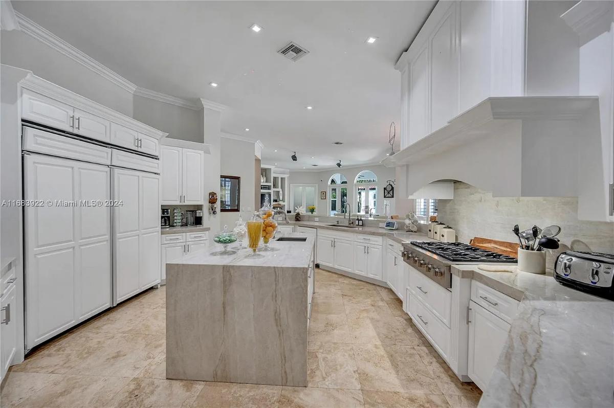 Kitchen with custom cabinetry and a center island prep area.