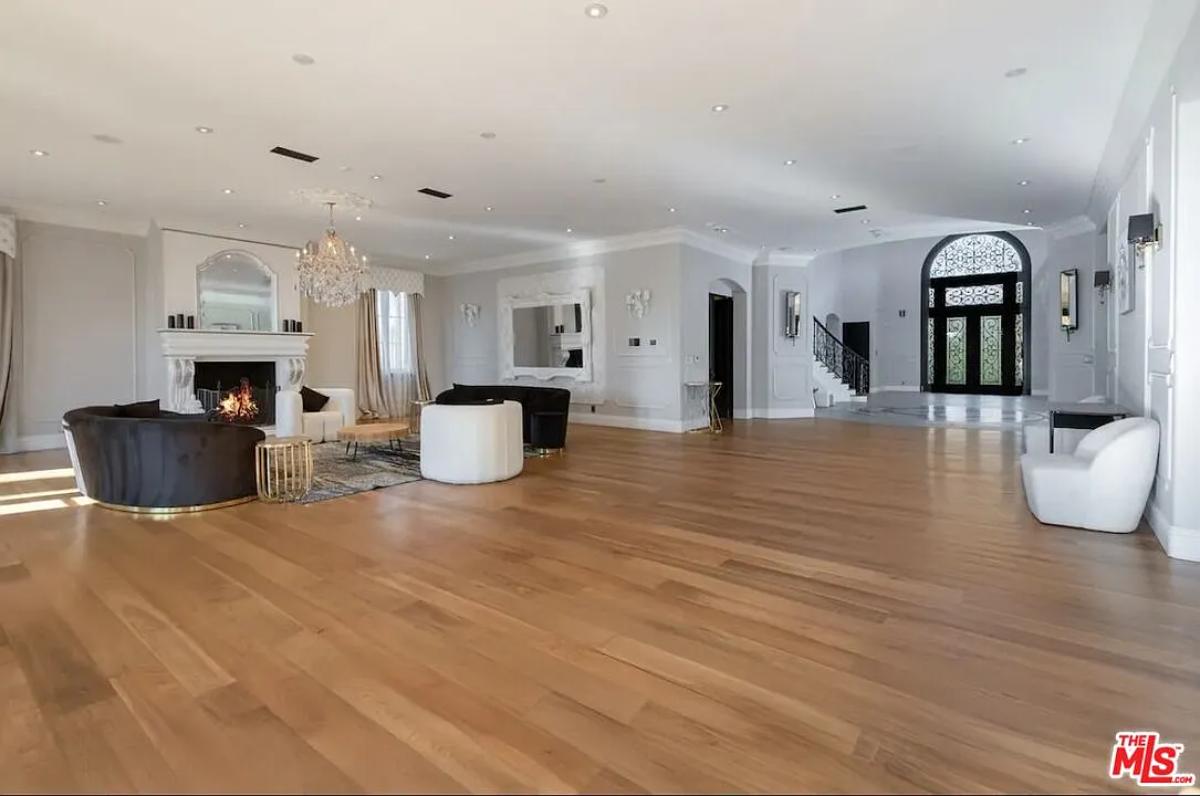 Living room with couches, a chandelier and a fireplace.