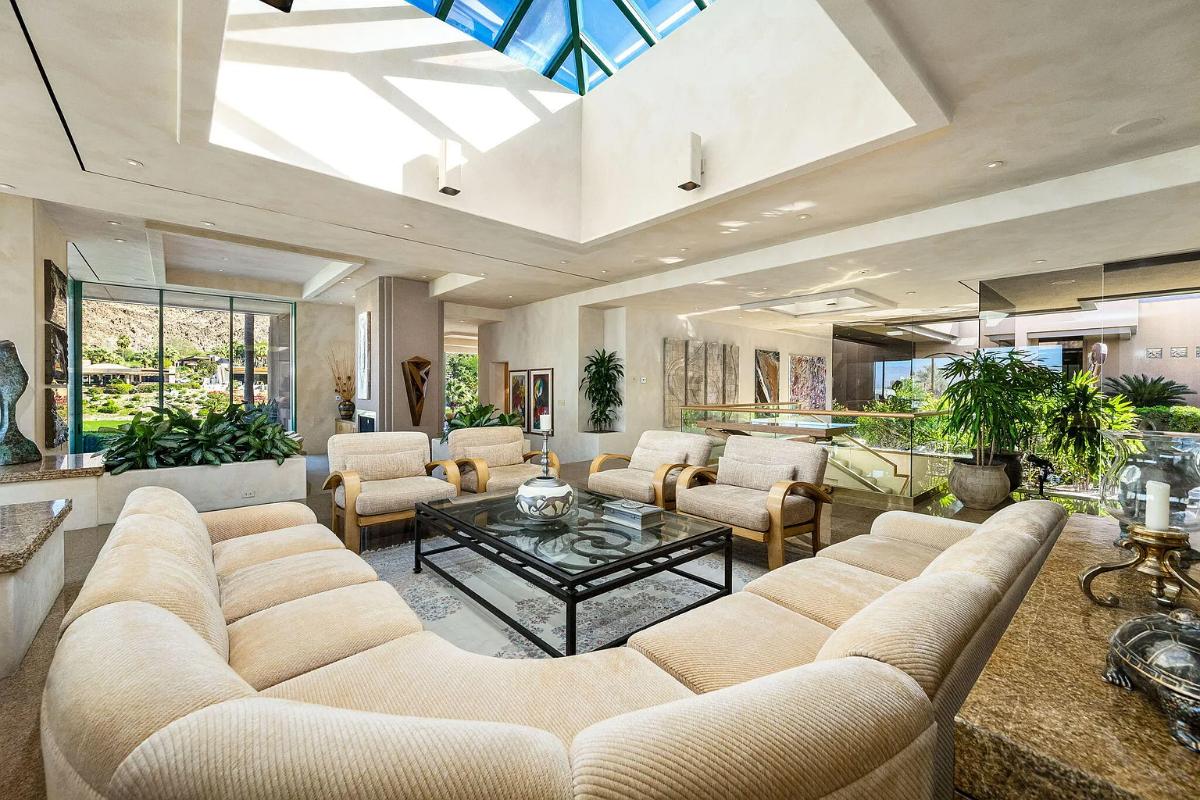 Living room with couches and skylight.