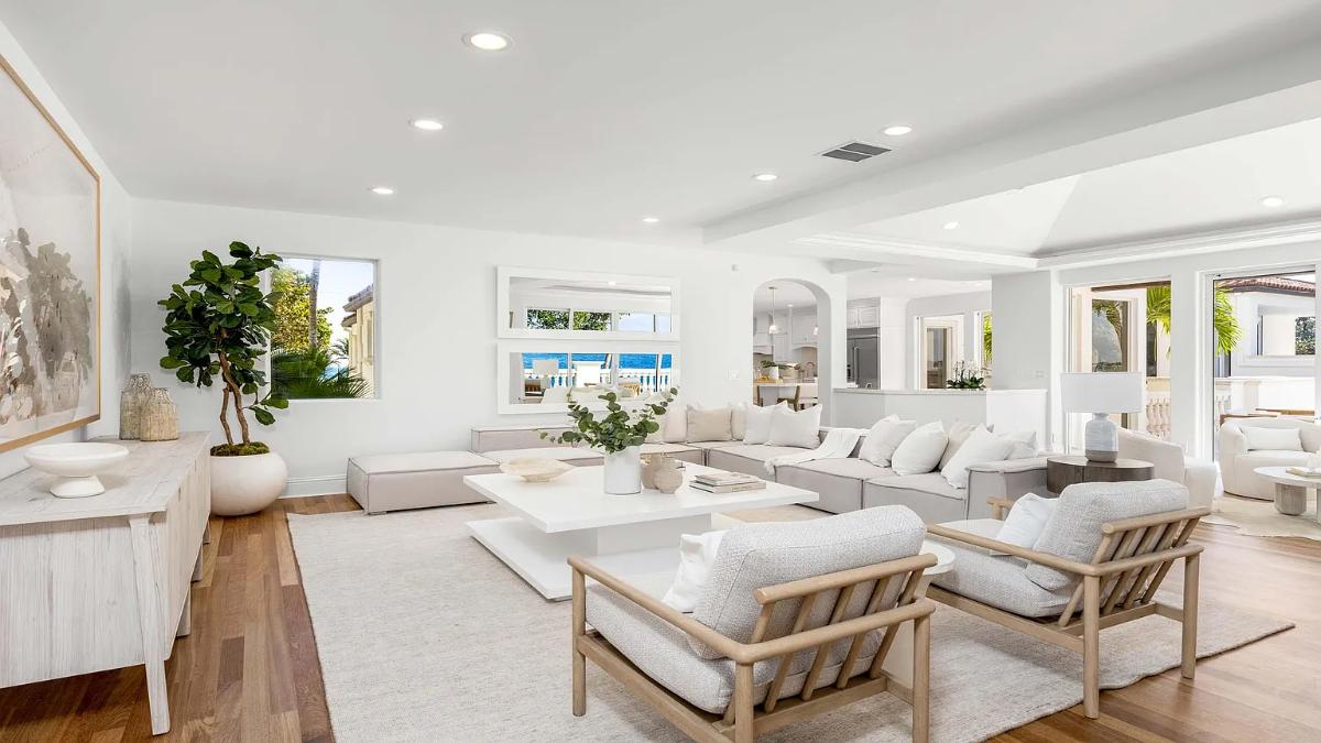 Living room with couches and hardwood floors.