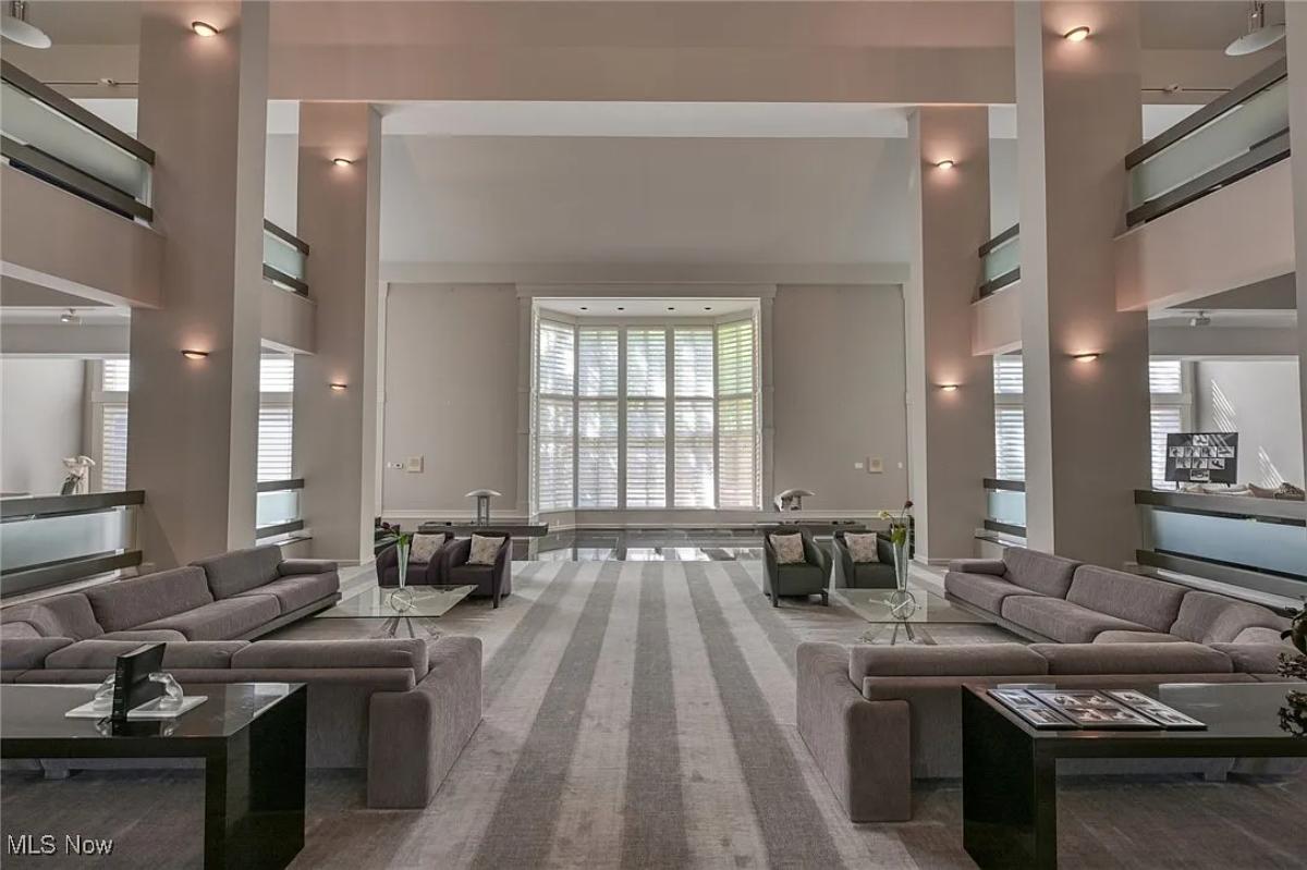 Living room with couches and high ceilings.