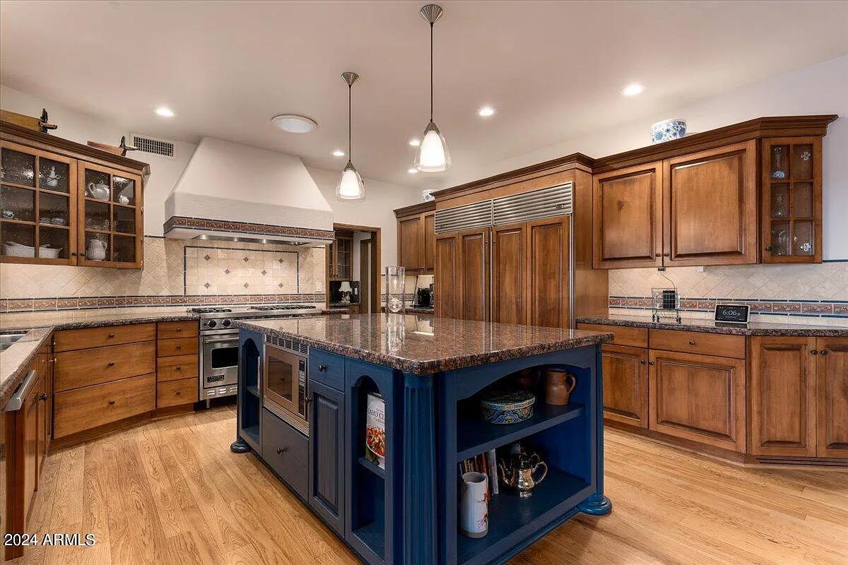 Kitchen with custom cabinetry and a center island prep area.
