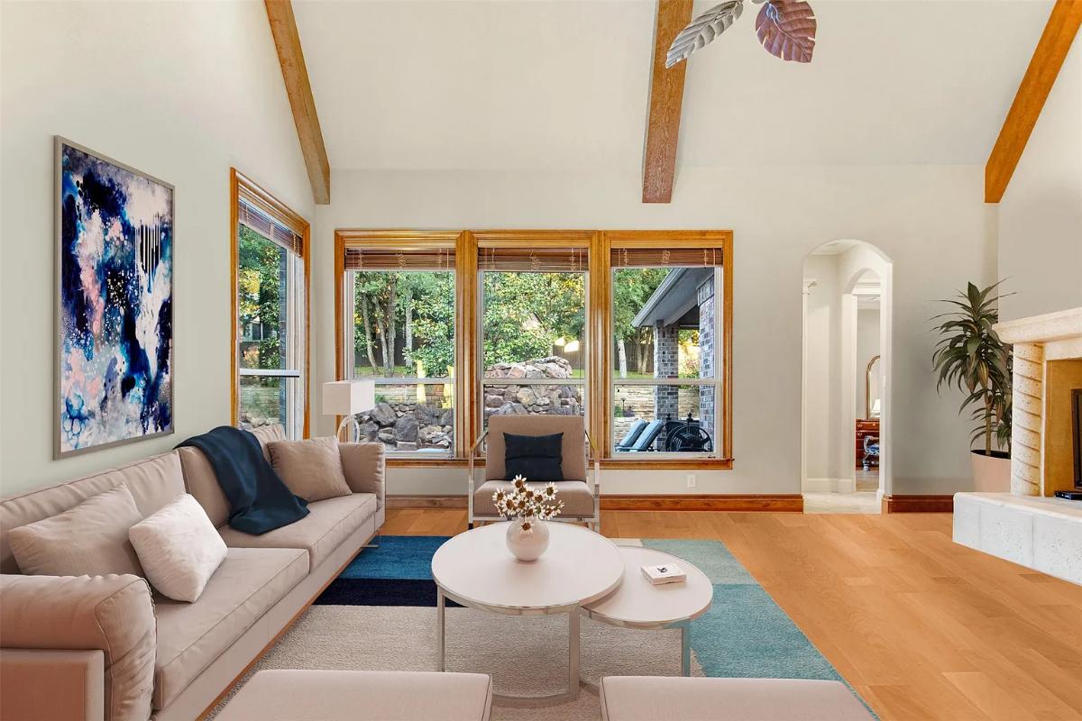 Living room with couches and glass windows.
