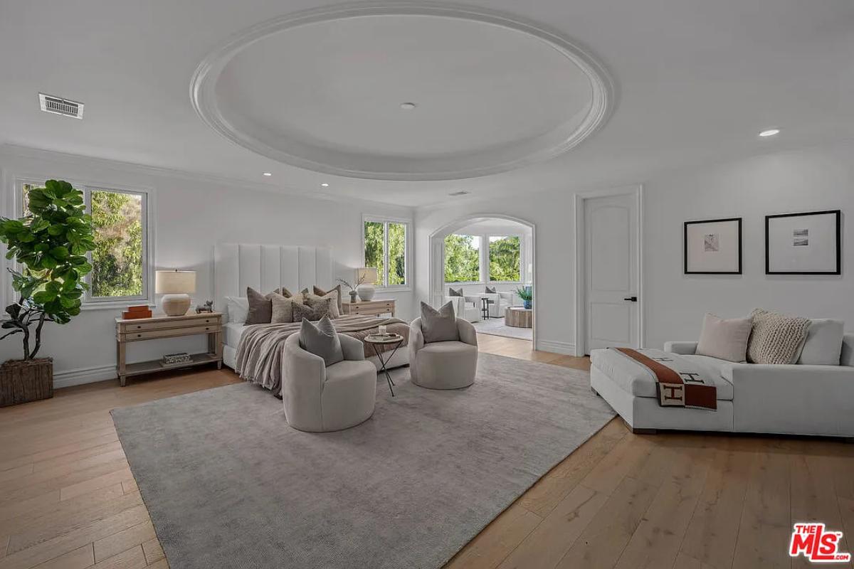 Bedroom with a large bed and hardwood floors.