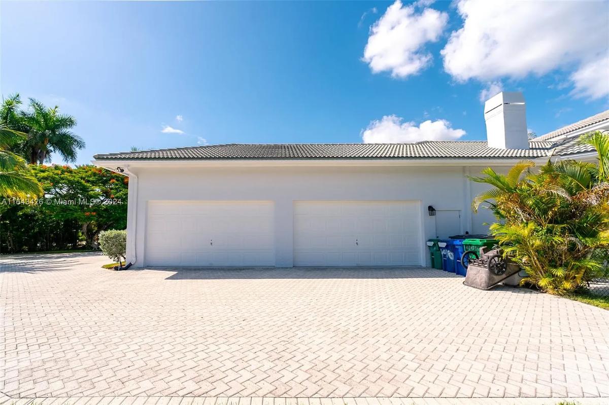 Garage with a spacious driveway.