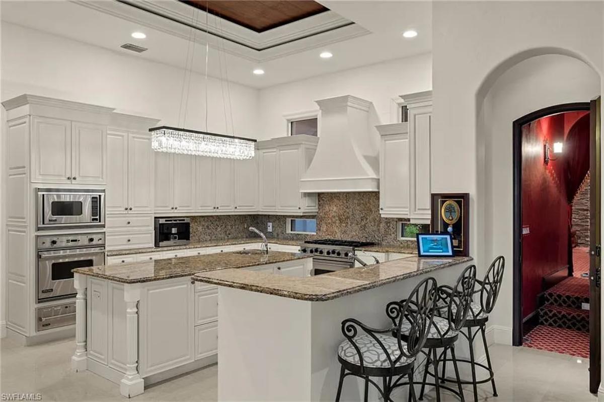 Kitchen with stainless-steel appliances, a counter breakfast bar and a center island prep area.