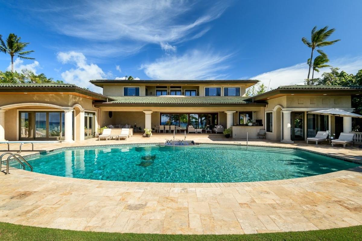 Rear view of the mansion with a pool.