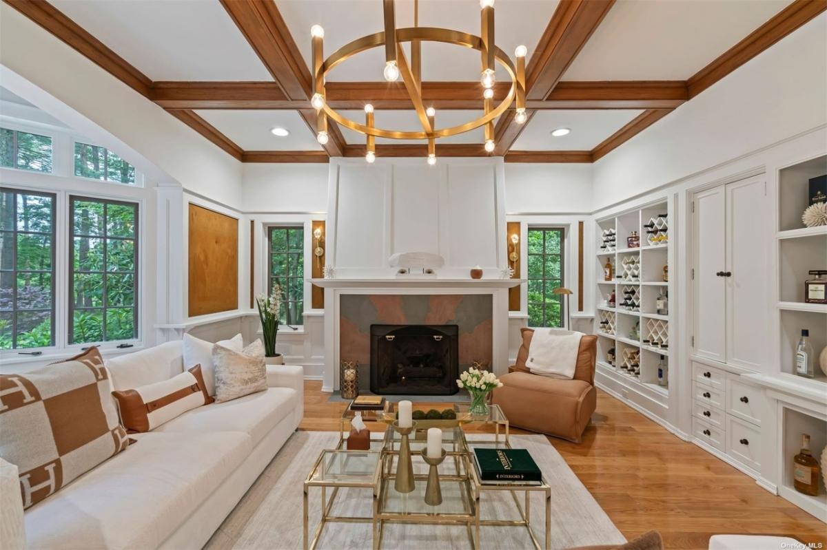 Living room with couches and a fireplace.
