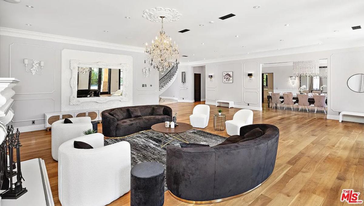 Living room with couches, a chandelier and a fireplace.