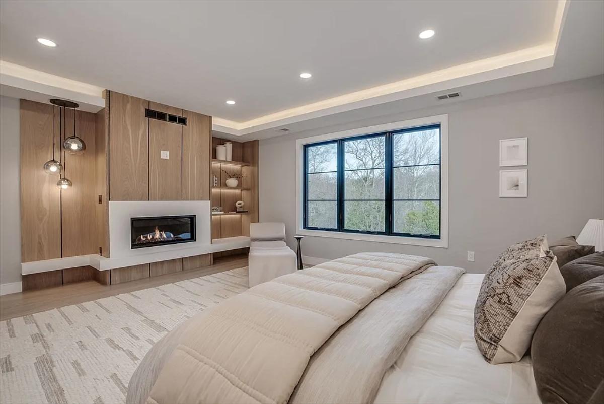 Bedroom with a large bed and a fireplace.