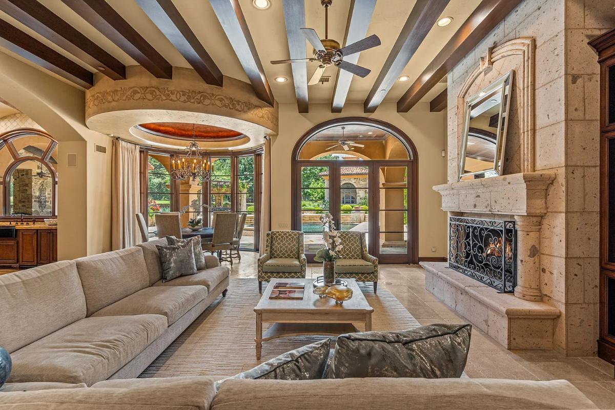 Living room with couches, vaulted ceilings and a fireplace.
