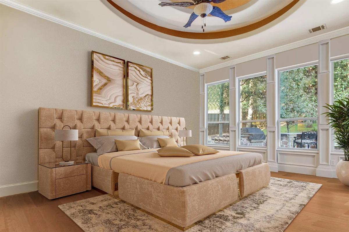 Bedroom with a large bed, glass windows and hardwood floors.